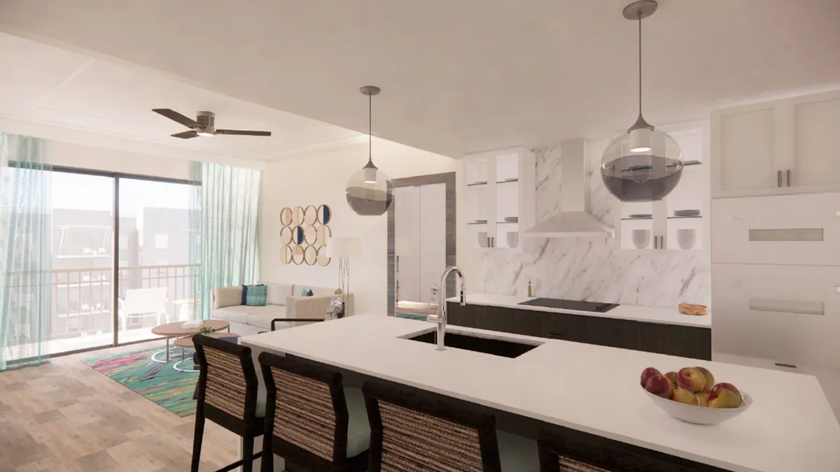 A chic, inviting interior scene highlighting an island countertop, stylish hanging light fixtures, marble backsplash, and colorful wall art. Visible from the kitchen are cozy seating and glimpses of the living area, reinforcing the connection between cooking, dining, and lounging. The setting hints at leisurely meals, game nights, and shared moments.